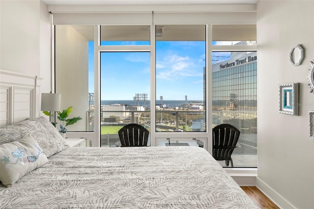 bedroom featuring baseboards and wood finished floors