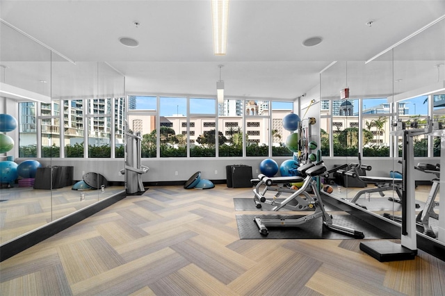 workout area featuring light colored carpet and a city view