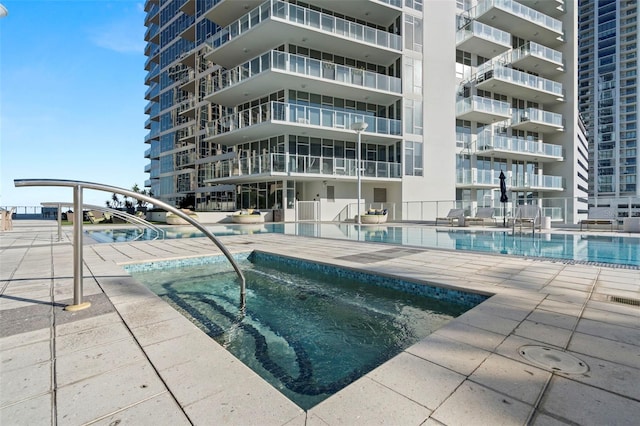 view of swimming pool featuring a community hot tub