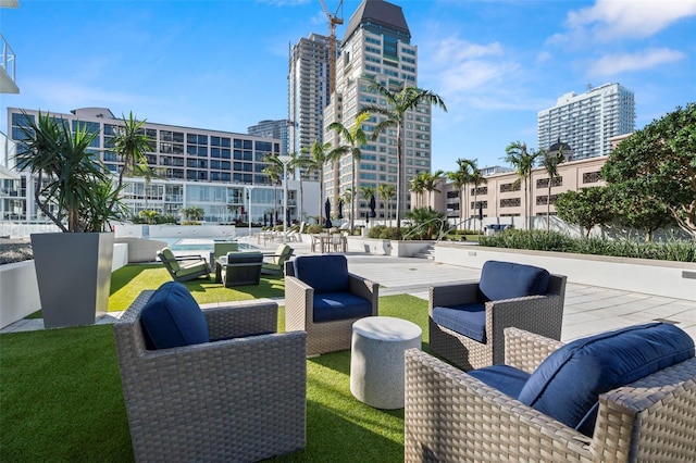 view of patio / terrace with an outdoor living space and a city view