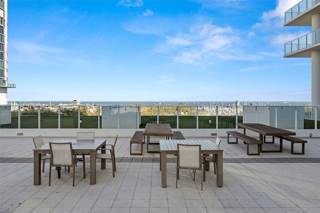 view of patio featuring outdoor dining space and a water view