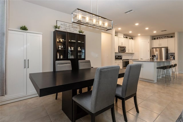 dining room with light tile patterned floors, visible vents, and recessed lighting