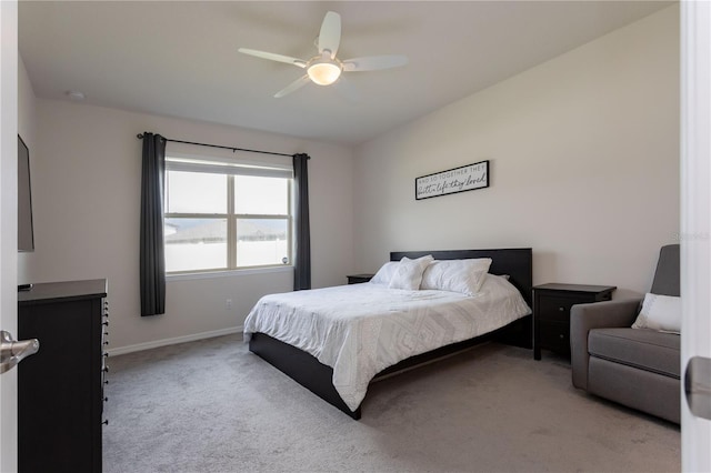 bedroom featuring light carpet, ceiling fan, and baseboards