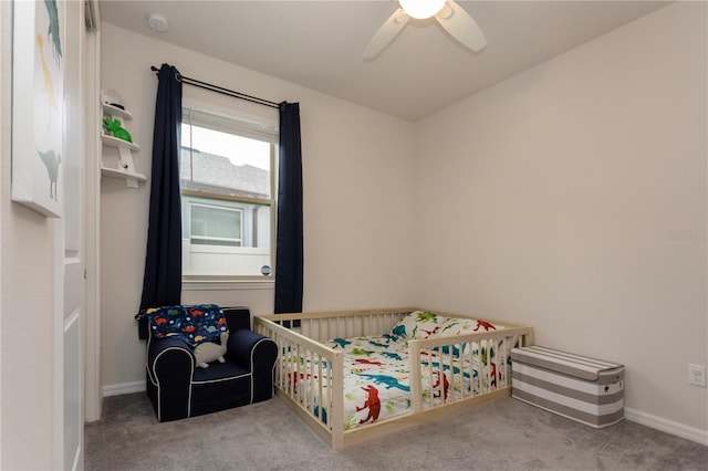 bedroom with ceiling fan, baseboards, and light colored carpet