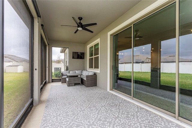 unfurnished sunroom featuring a ceiling fan