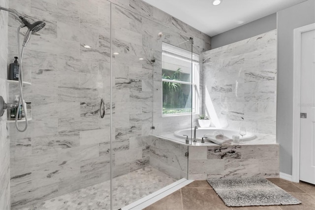 bathroom featuring a garden tub and a marble finish shower