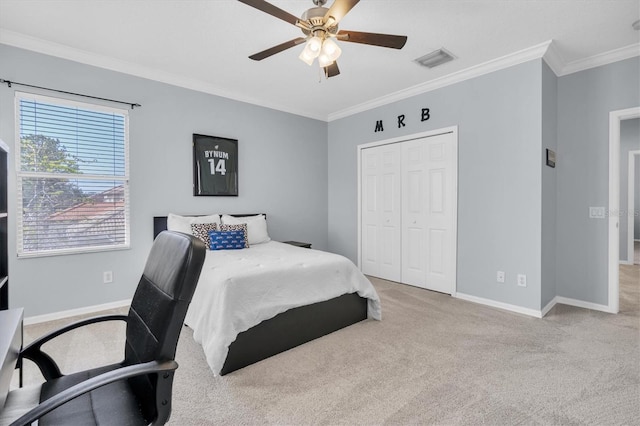 bedroom with visible vents, baseboards, ornamental molding, a closet, and carpet