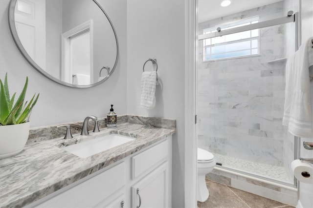 bathroom with toilet, a stall shower, tile patterned floors, and vanity