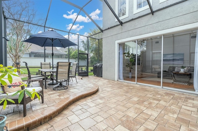 view of patio / terrace featuring outdoor dining space and a lanai