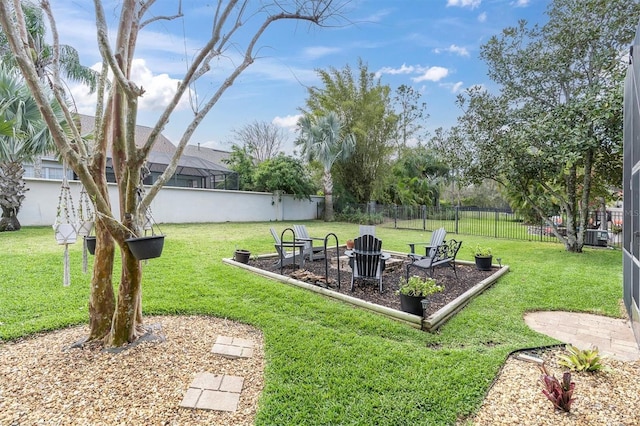 view of yard featuring a fenced backyard and a fire pit