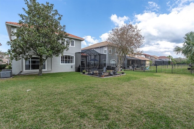 view of yard with central air condition unit, a fenced backyard, a lanai, and a residential view