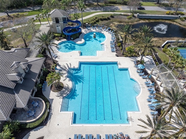 community pool featuring a patio area and a water slide