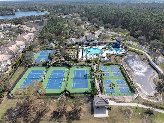 aerial view featuring a water view and a wooded view