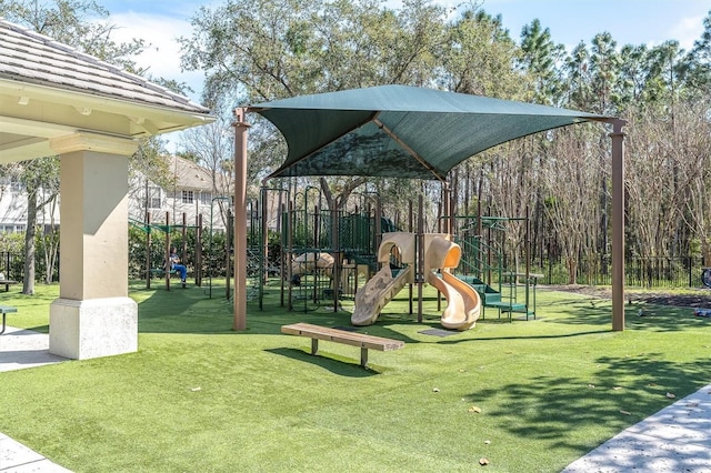 community jungle gym featuring a yard