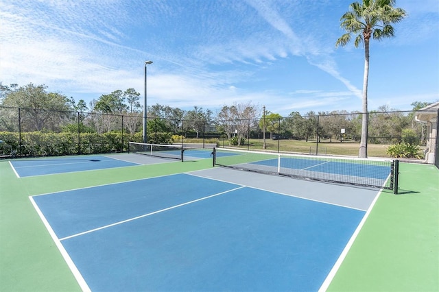 view of sport court with fence