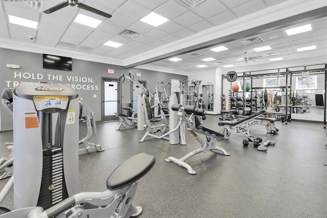 workout area with ornamental molding, a paneled ceiling, visible vents, and a ceiling fan