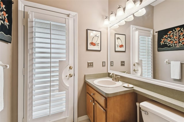 bathroom featuring toilet and vanity