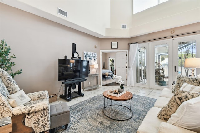 living room with a wealth of natural light, visible vents, and tile patterned floors