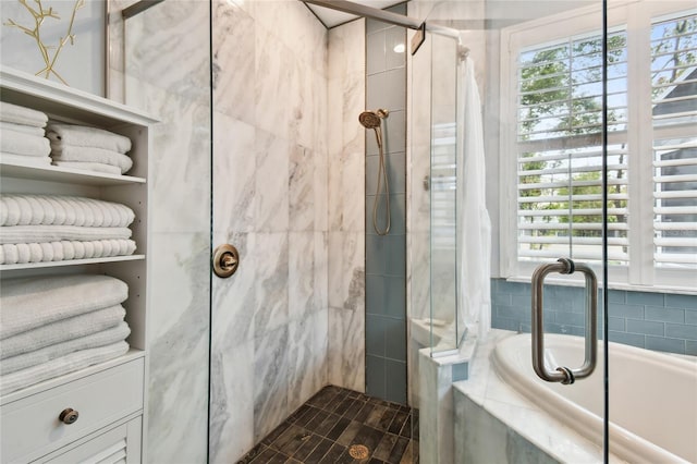 bathroom featuring a stall shower and a bath