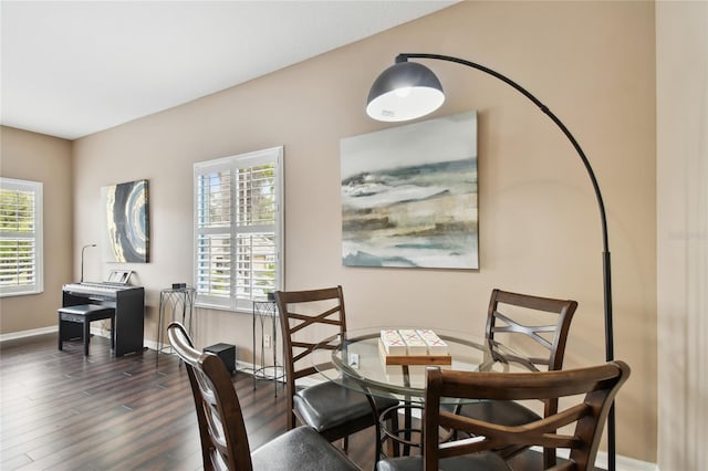 dining area with baseboards and dark wood-style flooring