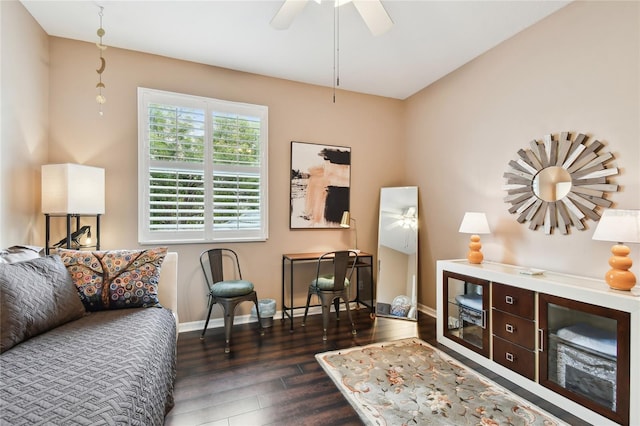 living room featuring baseboards, dark wood-style flooring, and ceiling fan