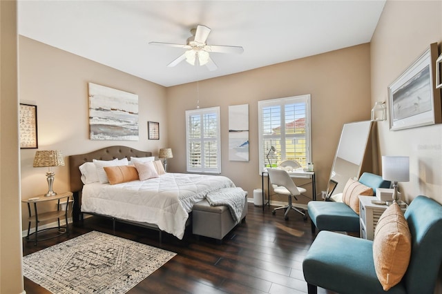 bedroom featuring a ceiling fan, dark wood-type flooring, and baseboards