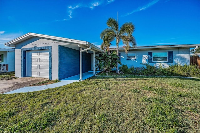 single story home with a garage, brick siding, driveway, and a front lawn