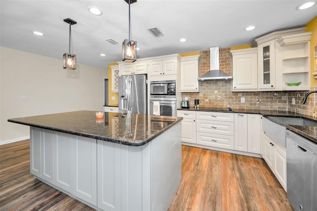 kitchen featuring decorative light fixtures, open shelves, visible vents, appliances with stainless steel finishes, and wall chimney exhaust hood