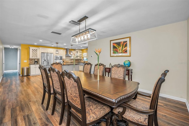 dining space with recessed lighting, dark wood-style flooring, visible vents, and baseboards