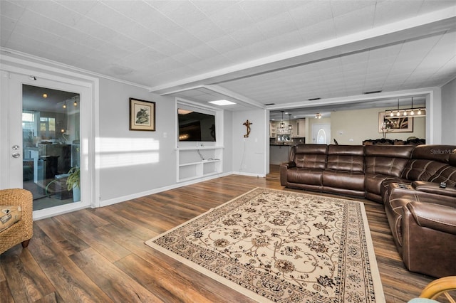 living area with wood finished floors and baseboards