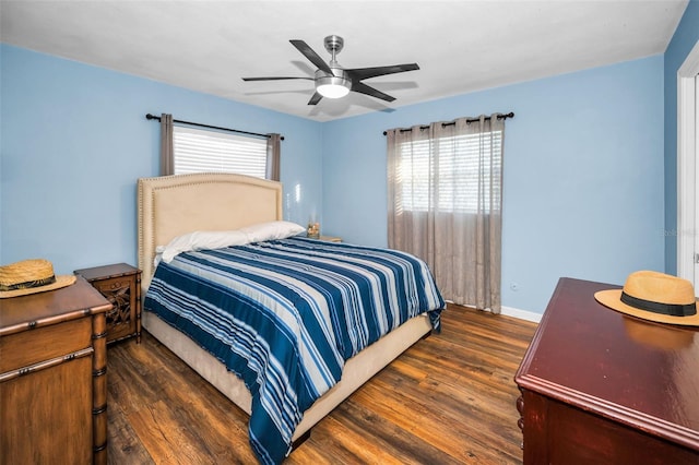 bedroom with ceiling fan, dark wood-style flooring, and baseboards