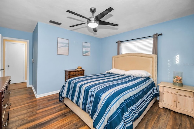 bedroom featuring ceiling fan, dark wood-type flooring, visible vents, and baseboards