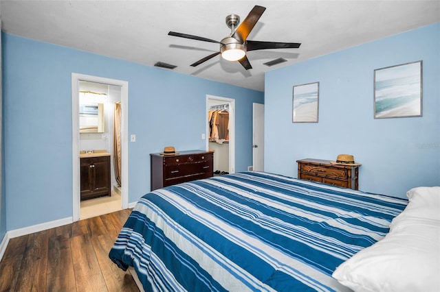 bedroom featuring a closet, visible vents, a spacious closet, and wood finished floors