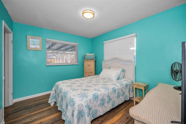 bedroom featuring dark wood-style floors and baseboards