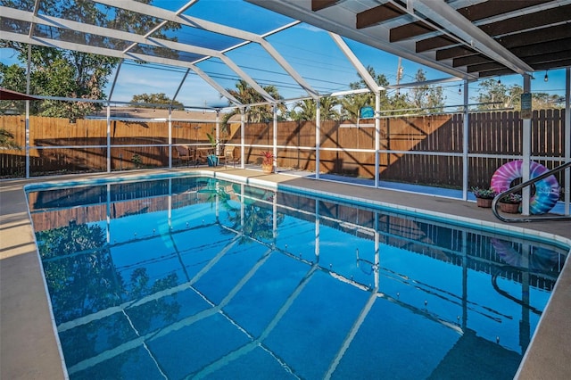 view of swimming pool with a fenced in pool, glass enclosure, and a fenced backyard