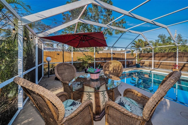 view of patio with a fenced in pool, glass enclosure, and a fenced backyard