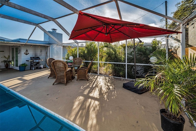 view of patio / terrace featuring glass enclosure and a grill