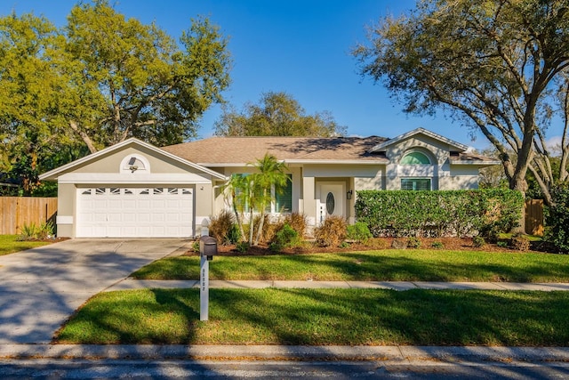 ranch-style house featuring driveway, stucco siding, an attached garage, fence, and a front yard