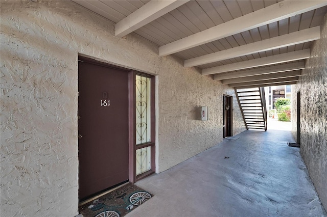 entrance to property featuring stucco siding