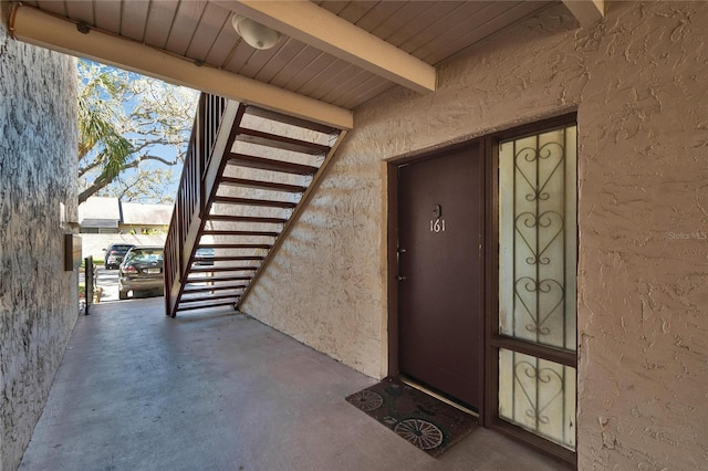 entrance to property with stucco siding