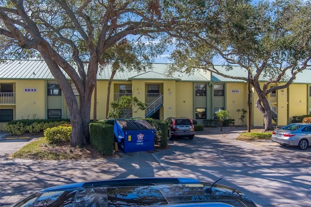 view of building exterior featuring uncovered parking