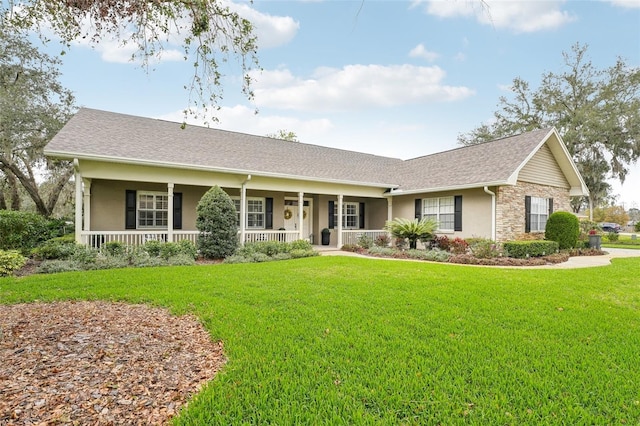 single story home featuring a porch, a shingled roof, stone siding, stucco siding, and a front yard