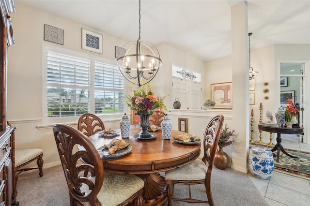 dining area with baseboards, light colored carpet, and an inviting chandelier