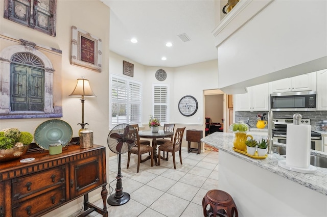 dining area featuring light tile patterned floors, visible vents, and recessed lighting