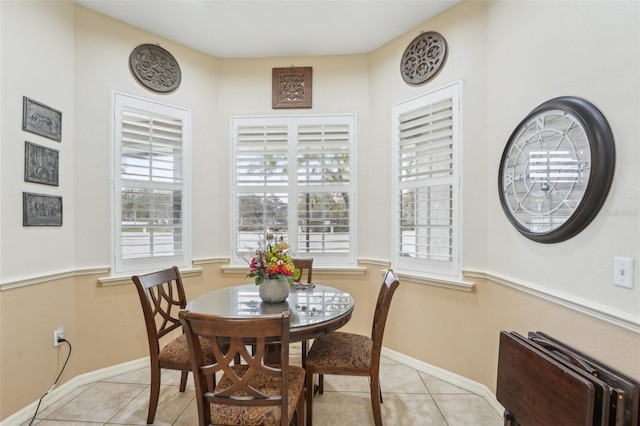 dining space with light tile patterned floors and baseboards