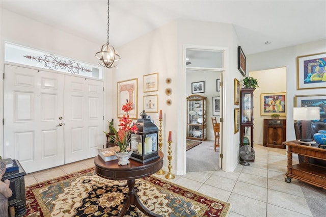 foyer entrance with a notable chandelier and light tile patterned floors