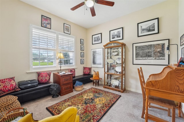 interior space with baseboards, a ceiling fan, and light colored carpet