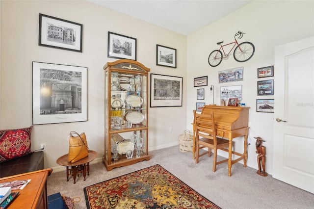 carpeted home office featuring baseboards