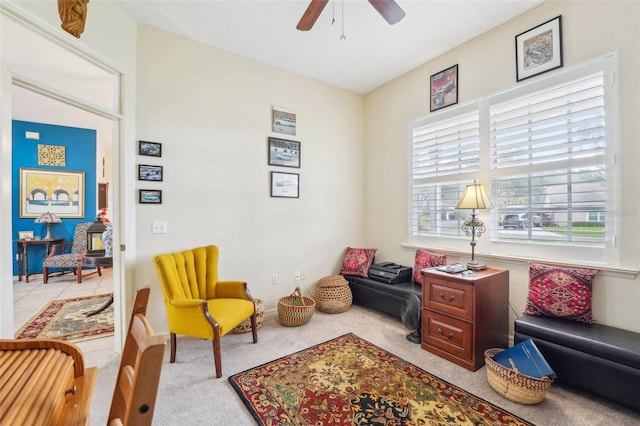 sitting room featuring light colored carpet and ceiling fan