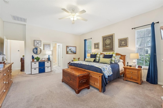 bedroom featuring ceiling fan, visible vents, and light colored carpet